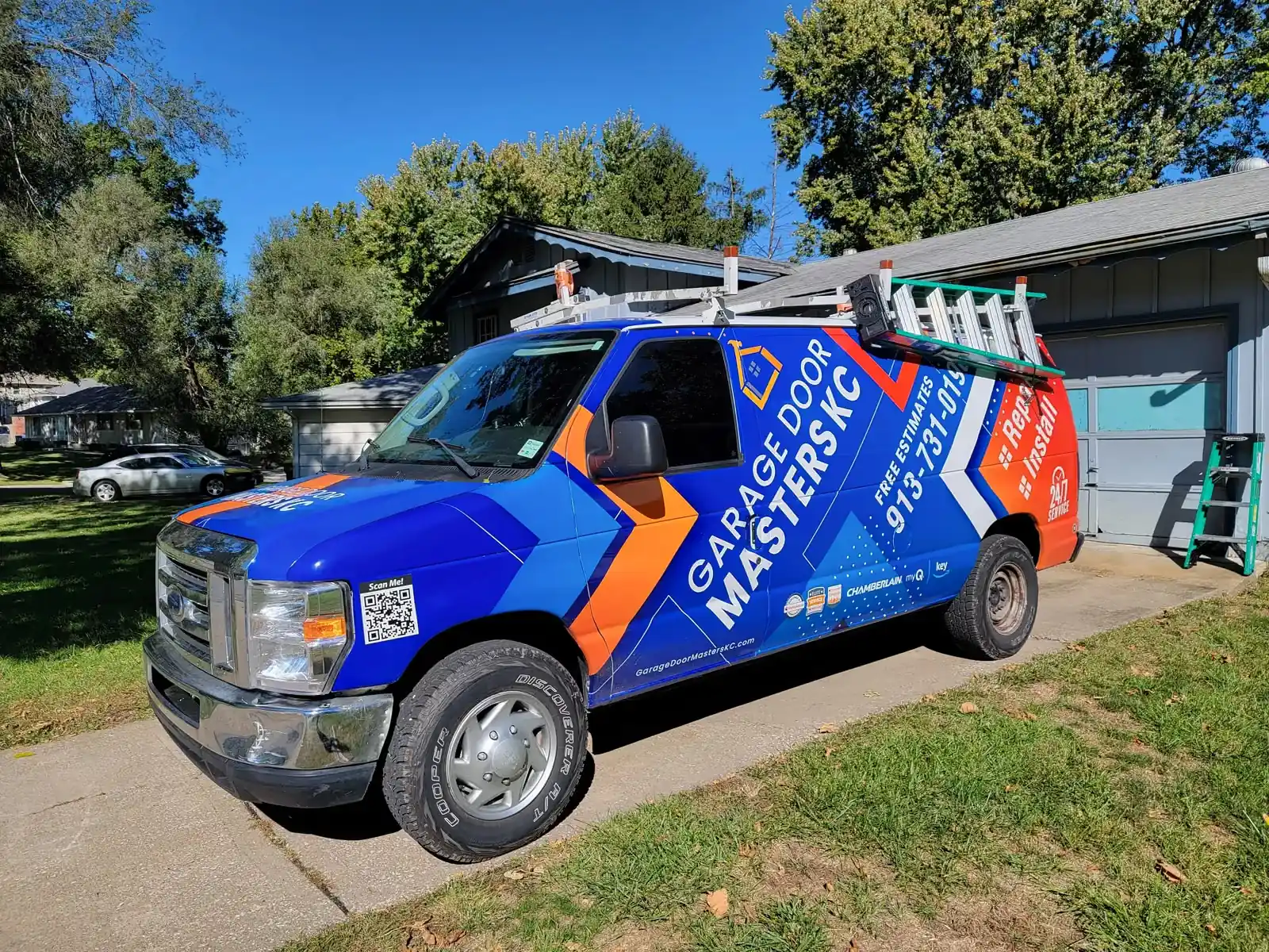 Garage Door Masters KC branded service van in a Kansas City driveway
