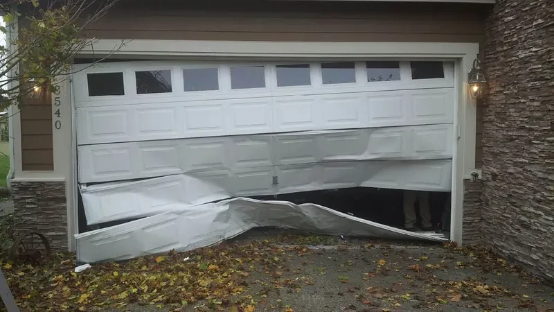 Before: a garage door damaged by a vehicle