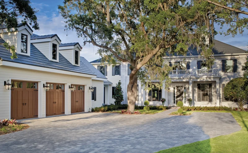 Clopay Canyon Ridge Collection faux-wood carriage garage doors on an estate home