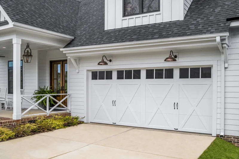 Clopay Coachman Collection carriage-house garage door on a white farmhouse