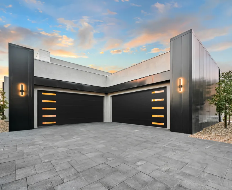 Clopay Modern Steel garage doors in a black Lustra finish on a contemporary home