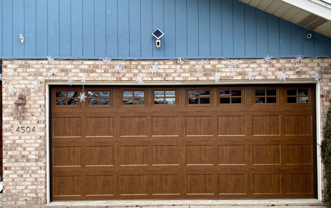 Steel insulated garage door installed on a Johnson County KS home with decorative windows